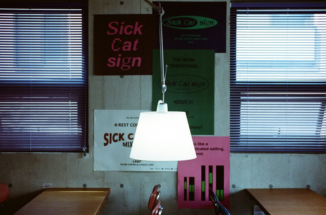 Colorful books on a desk with a lamp