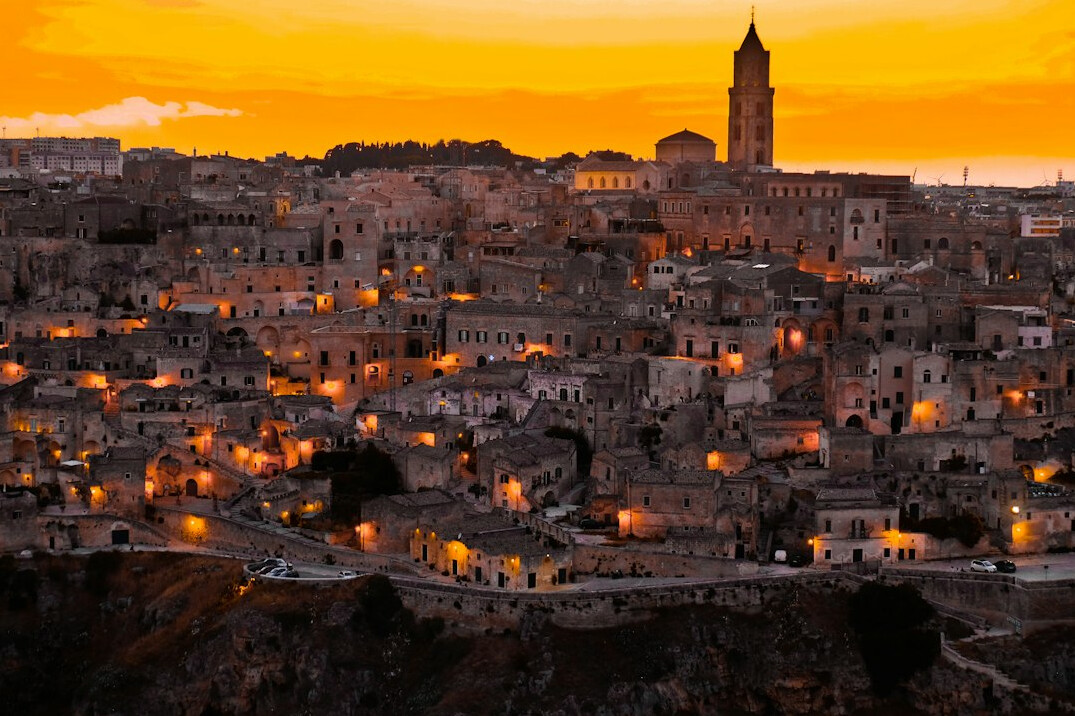 Old city skyline at night with warm lights